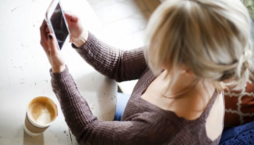 Free woman browsing smartphone photo